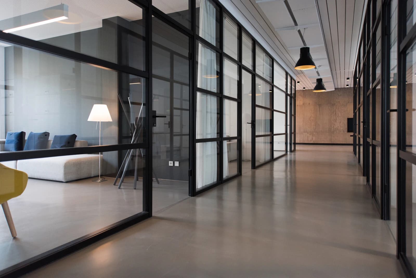 Polished commercial office corridor and glass-walled workspace maintained to high housekeeping standards