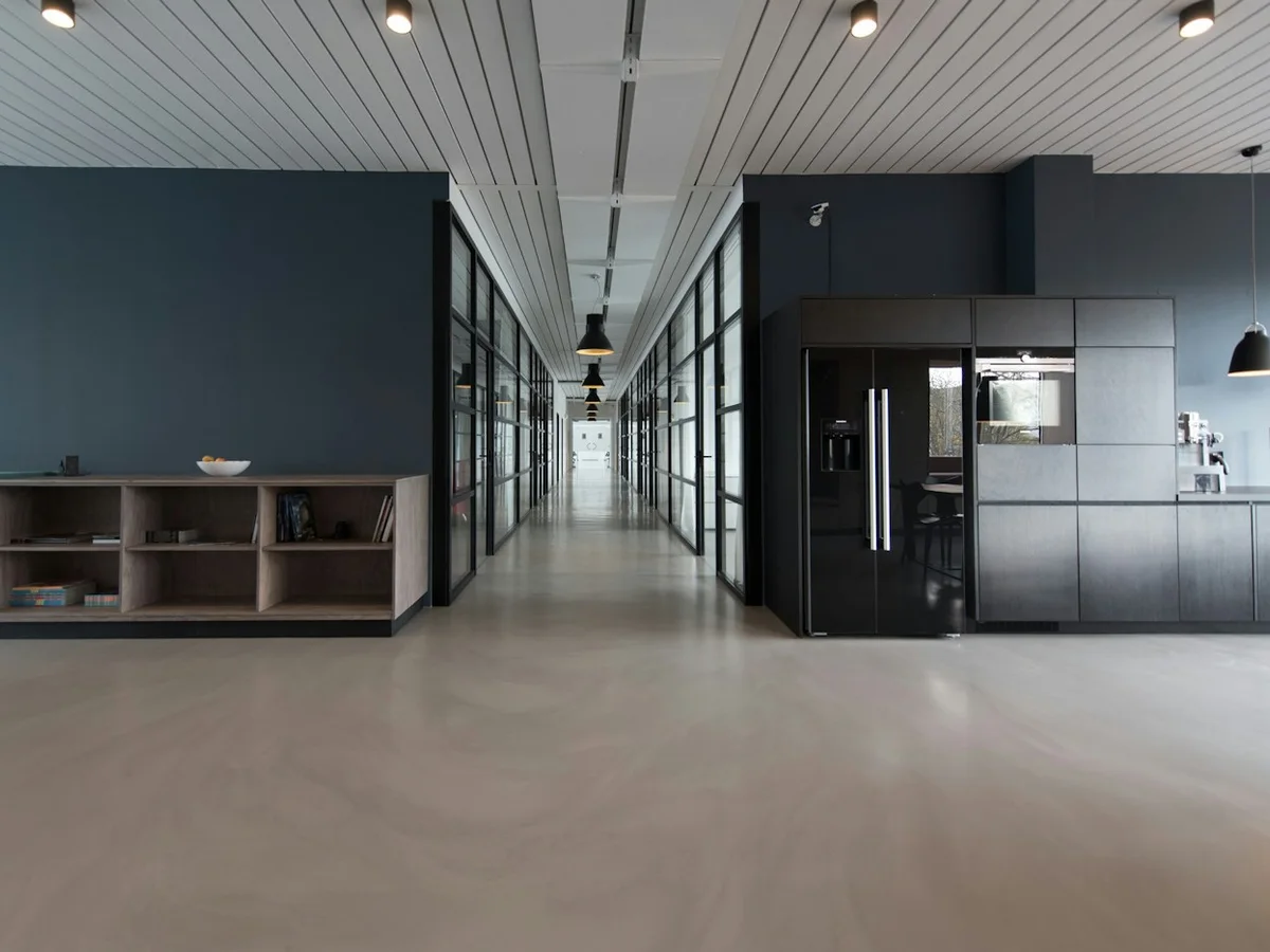 Contemporary corporate office interior with glass meeting rooms and polished floors